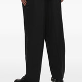 Pantaloni gessati con pieghe in nero Comme des garcons homme - uomo 