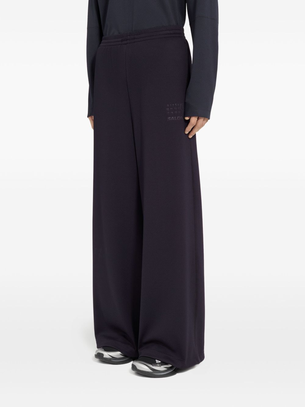 Pantaloni con coulisse sui orli in nero MM6 X Salomon - unisex 