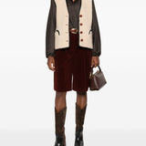 Gilet in shearling con profili in pelle in beige 