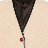 Gilet in shearling con profili in pelle in beige 