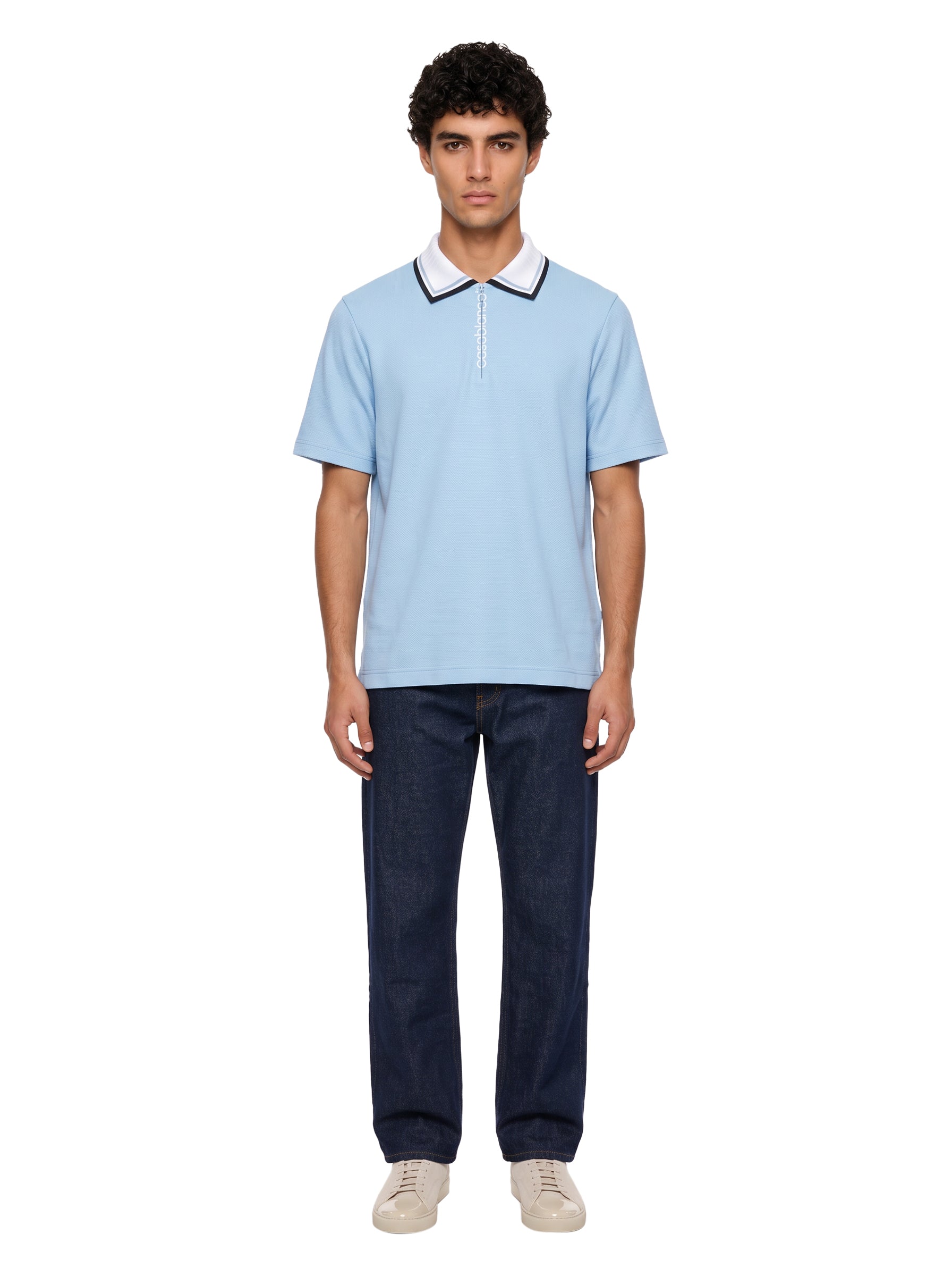 Polo con mezza zip in azzurro 
