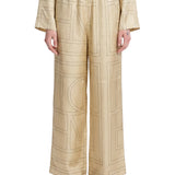 Pantaloni in seta con stampa monogramma in beige 