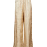 Pantaloni in seta con stampa monogramma in beige 