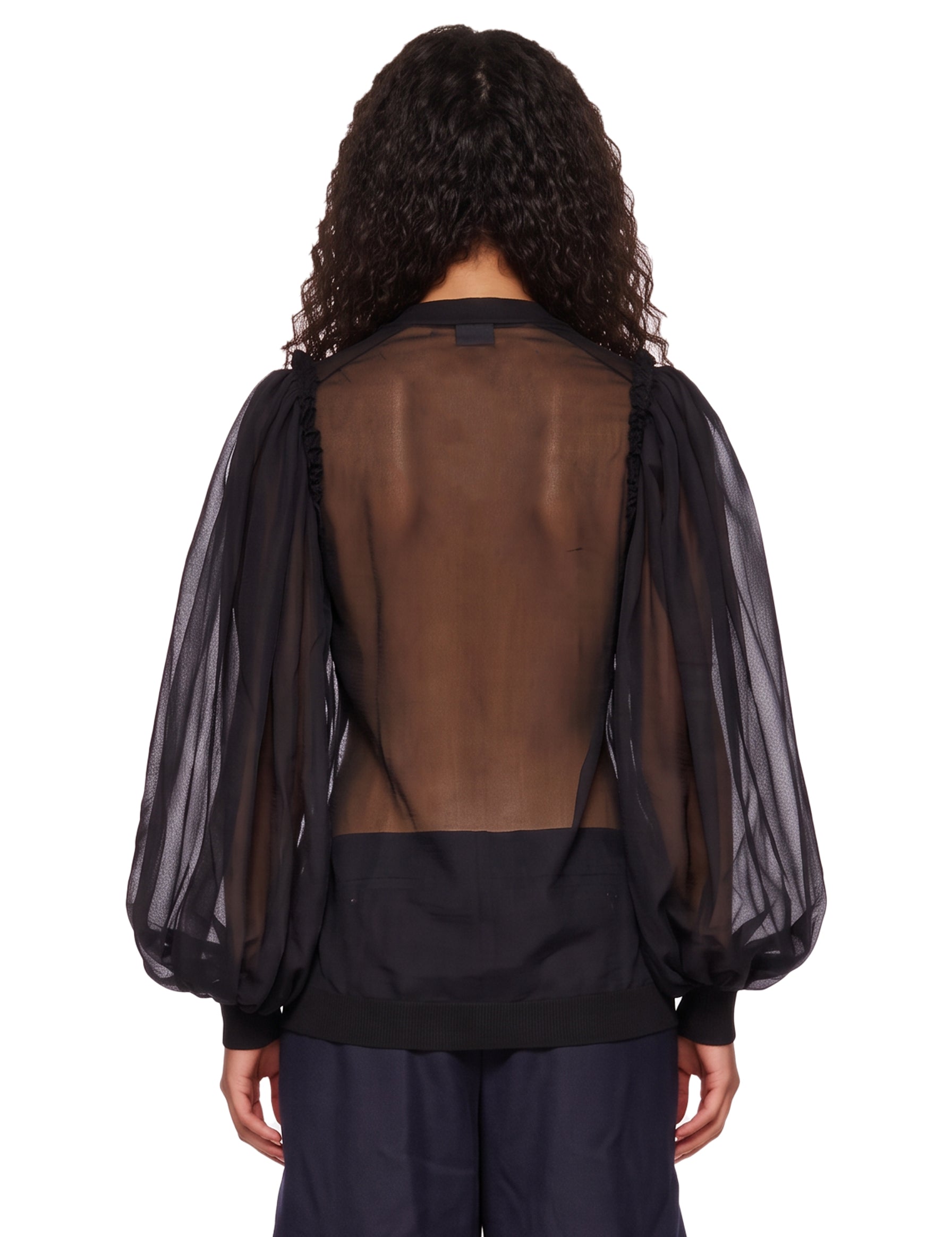Blusa semitrasparente in tulle in nero 