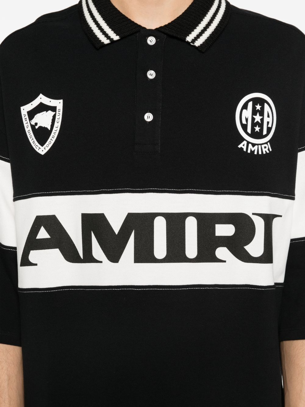 Polo con logo e dettagli a righe in nero e bianco Amiri - uomo 