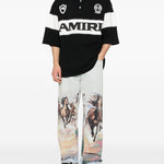Polo con logo e dettagli a righe in nero e bianco Amiri - uomo 