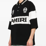 Polo con logo e dettagli a righe in nero e bianco Amiri - uomo 