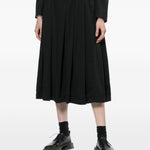 Gonna midi a pieghe con bretelle in nero COMME DES GARCONS BLACK - donna 