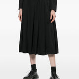 Gonna midi a pieghe con bretelle in nero COMME DES GARCONS BLACK - donna 