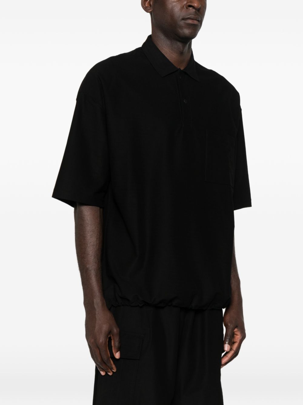 Polo con orlo elasticizzato in nero Comme des garcons homme - uomo 
