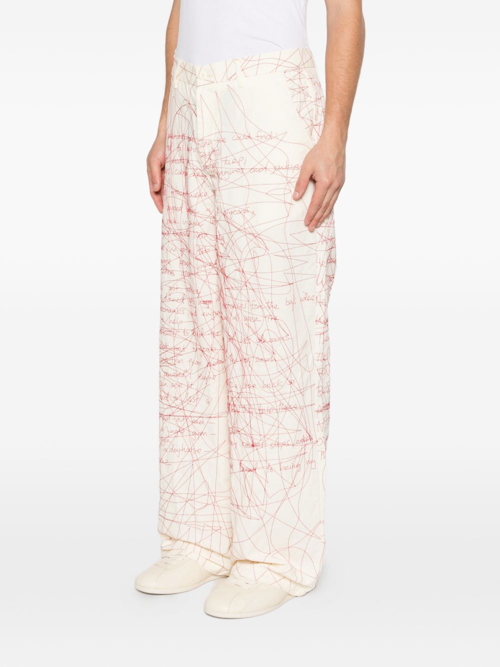 Pantaloni stampati con scrittura in bianco e rosso Kidsuper - uomo 