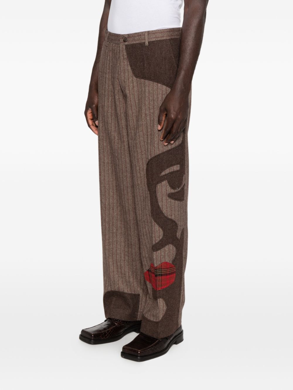 Pantaloni a righe con design patchwork  in marrone Kidsuper - uomo 