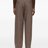 Pantaloni a righe con design patchwork  in marrone Kidsuper - uomo 