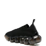 Sneakers con suola a bolle in nero Undercover - uomo 