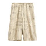 Shorts in seta con motivo monogram in beige 