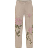 Pantaloni con dettaglio fiori in beige KidSuper - uomo 