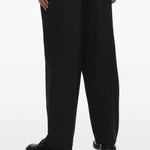 Pantaloni gessati con pieghe in nero Comme des garcons homme - uomo 
