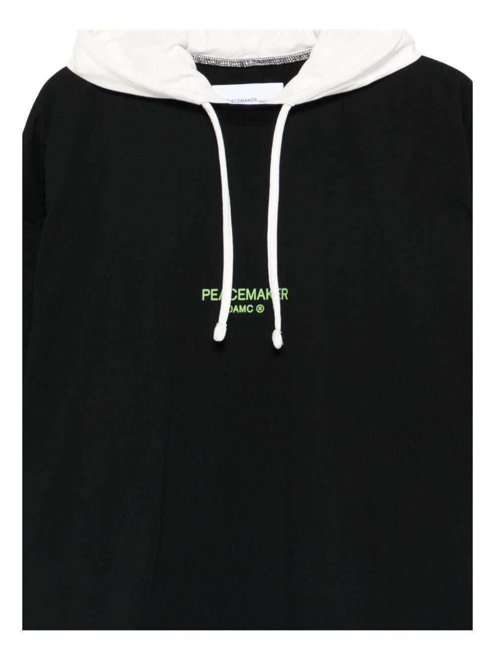 Felpa con cappuccio dynamo in nero e bianco Oamc peacemaker - uomo 