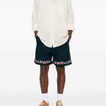 Shorts in twill con ricami floreali in blu Found - uomo 