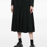 Gonna midi a pieghe con bretelle in nero COMME DES GARCONS BLACK - donna 