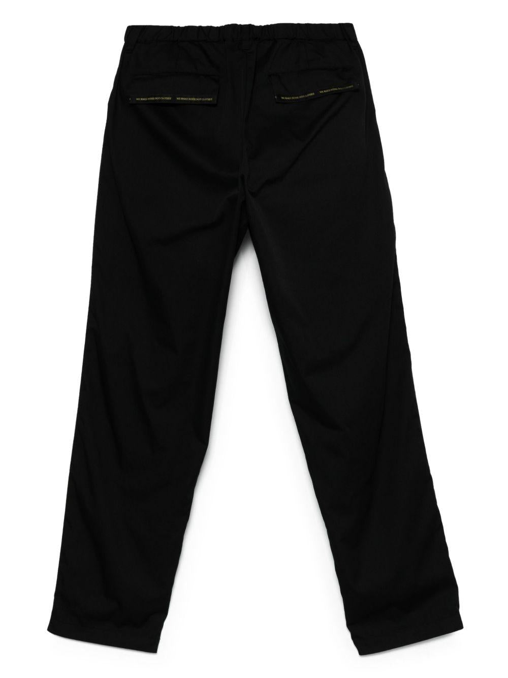 Pantaloni con banda logo in nero Undercover - uomo 