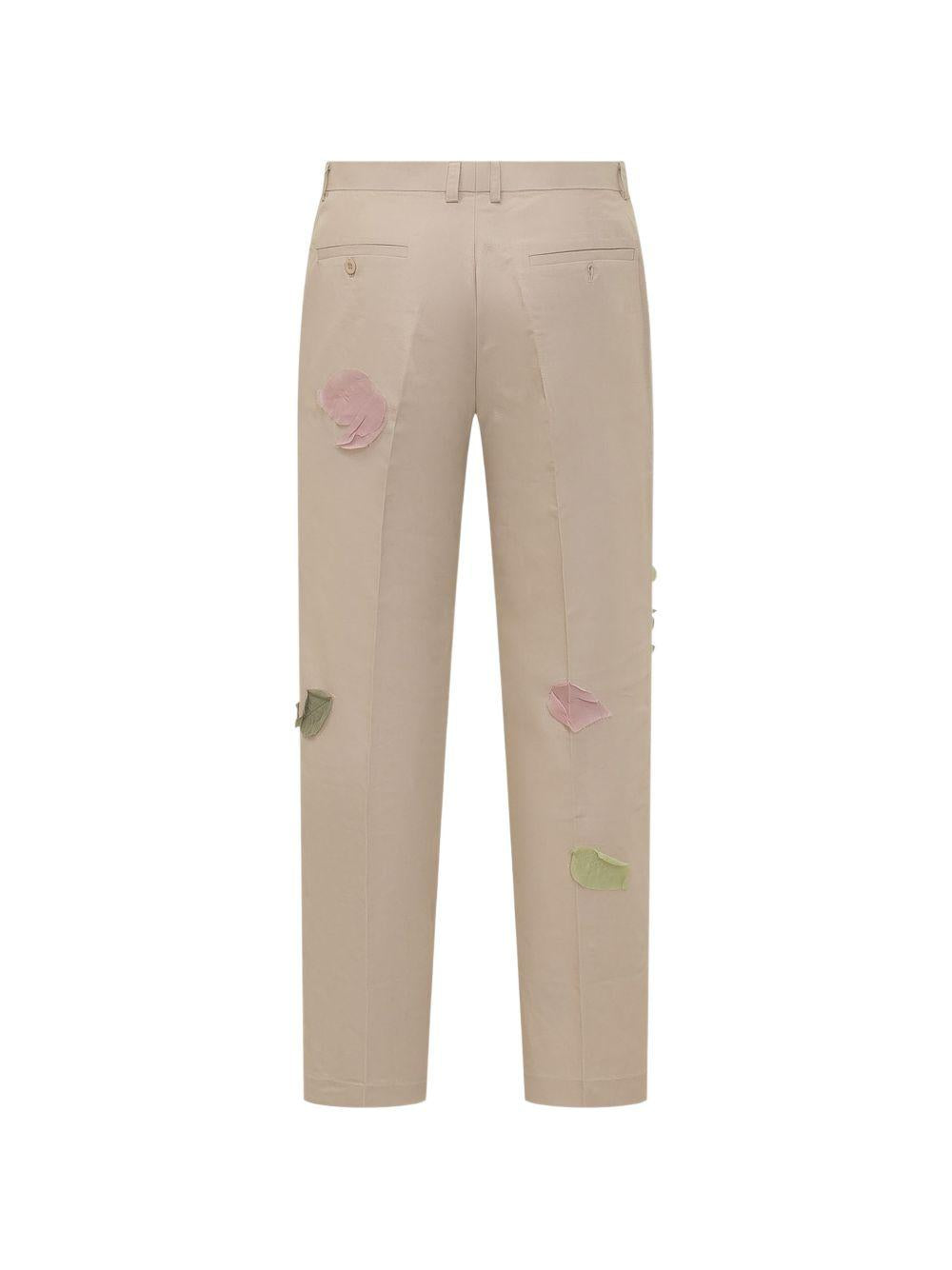 Pantaloni con dettaglio fiori in beige KidSuper - uomo 