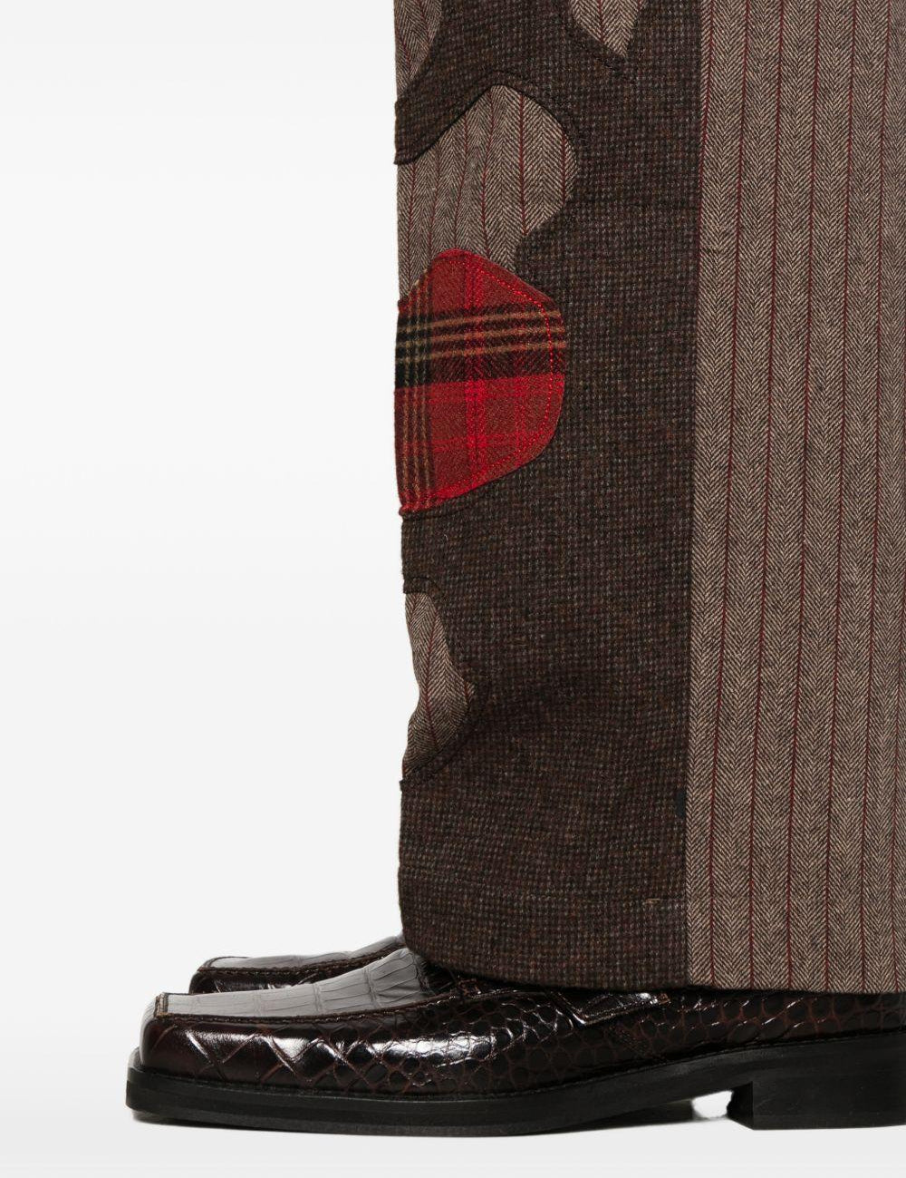 Pantaloni a righe con design patchwork  in marrone Kidsuper - uomo 