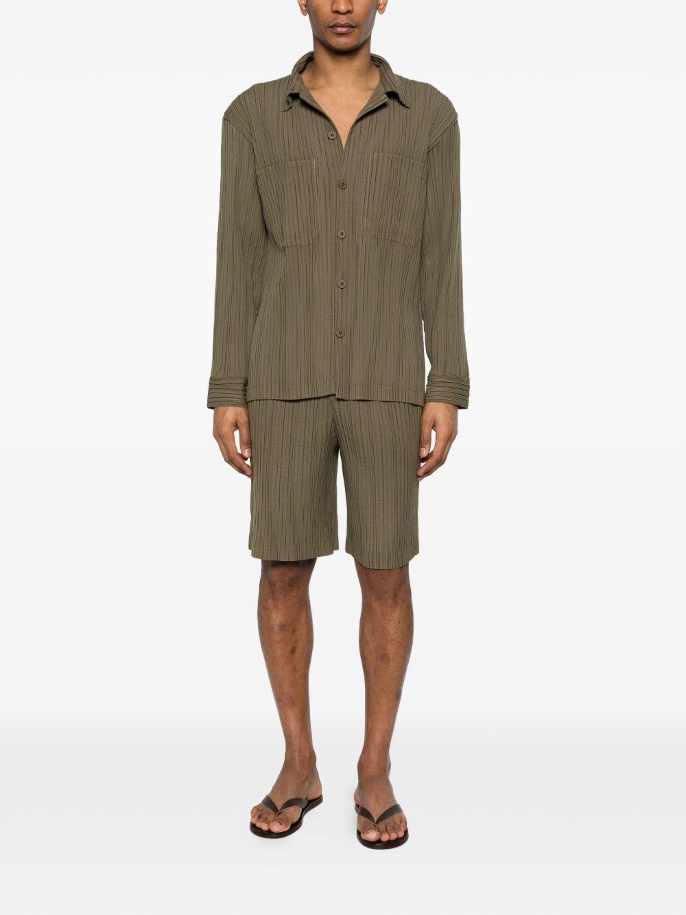 Pantaloncini elasticizzati con pieghe in verde Gongdid design - uomo 