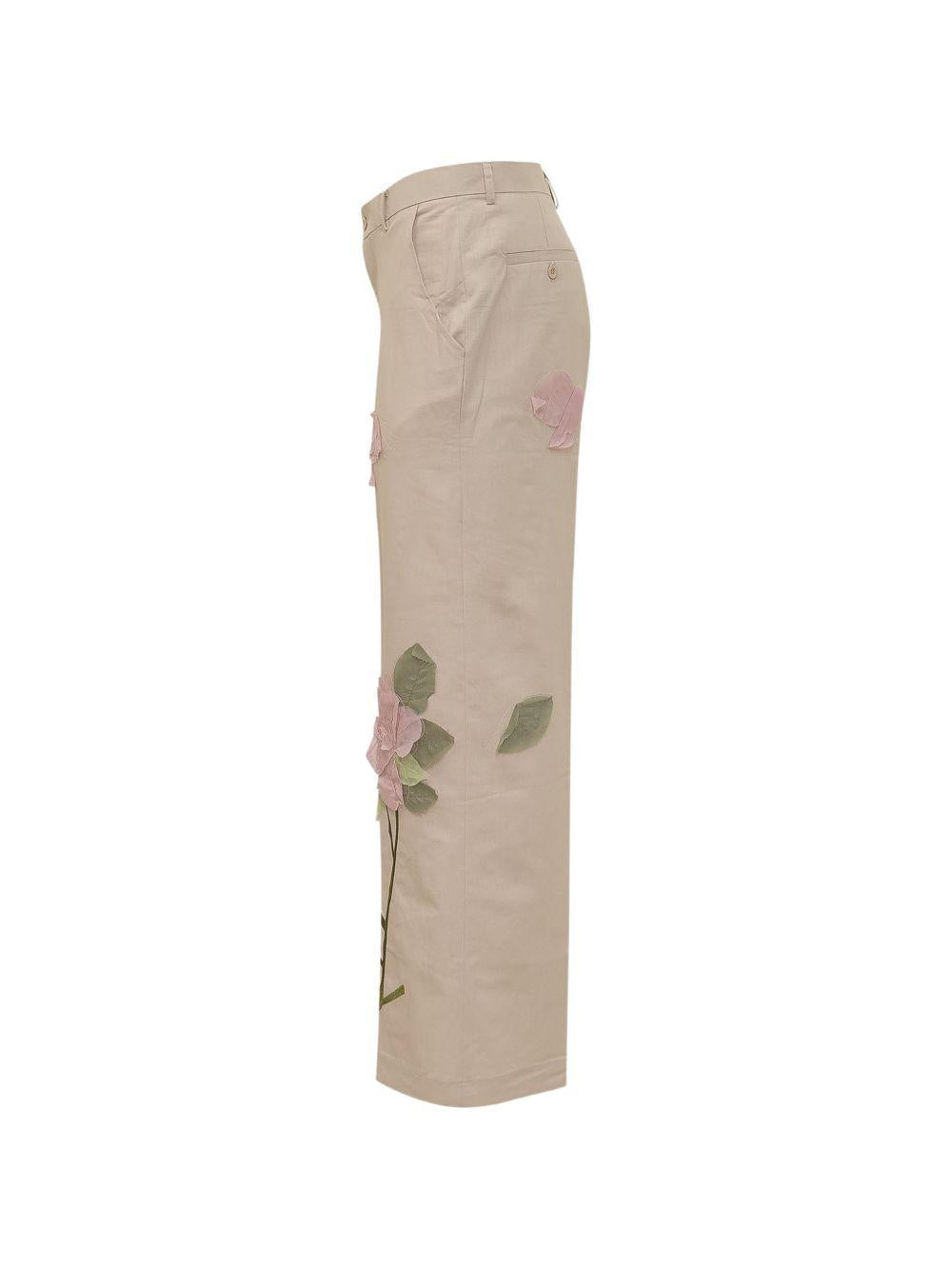 Pantaloni con dettaglio fiori in beige KidSuper - uomo 