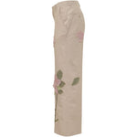 Pantaloni con dettaglio fiori in beige KidSuper - uomo 