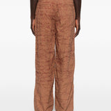 Pantaloni con motivo a scrittura ricamata in marrone Kidsuper - uomo 