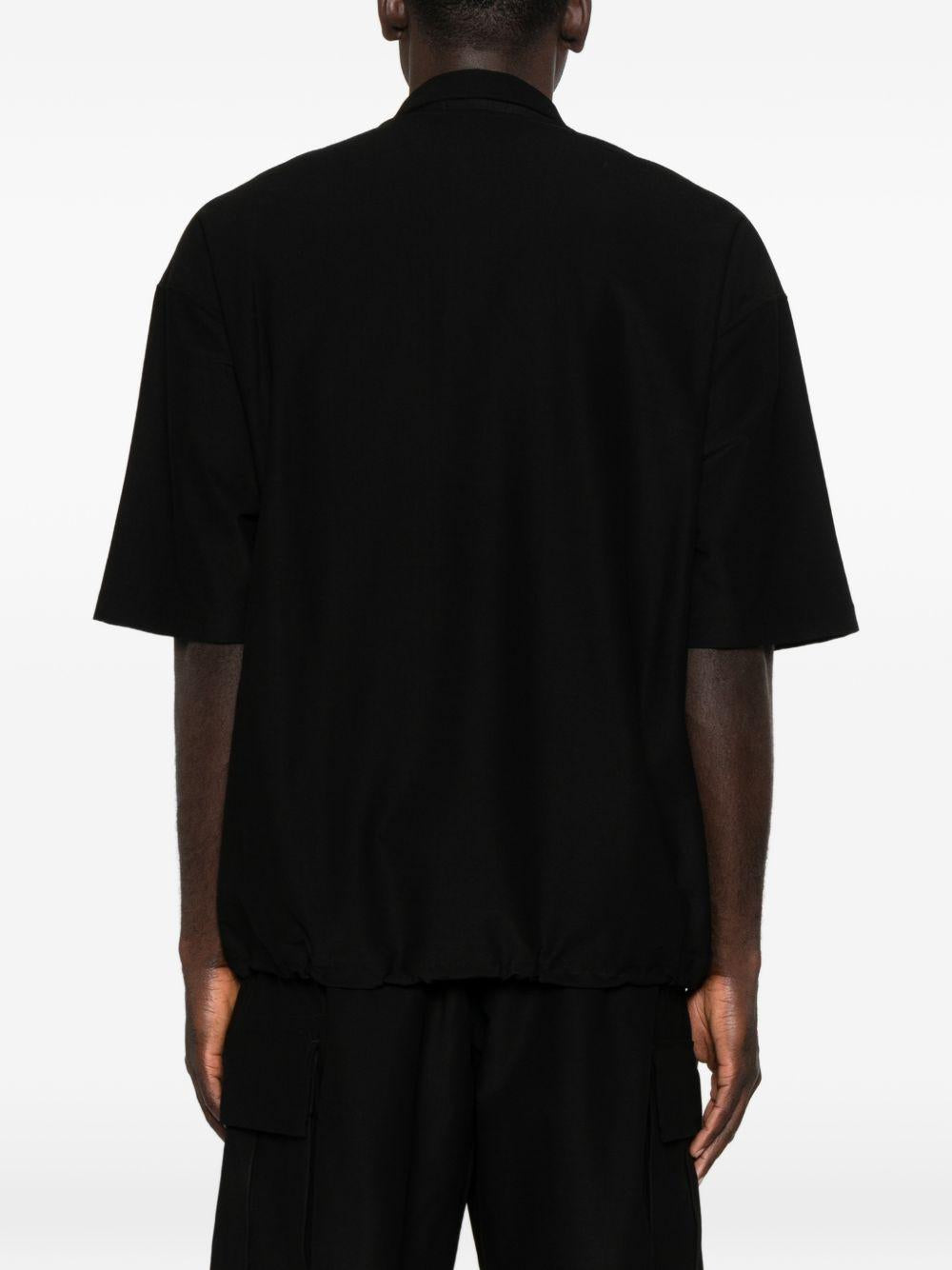 Polo con orlo elasticizzato in nero Comme des garcons homme - uomo 