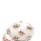 Clutch ovale con fiori in crema 
