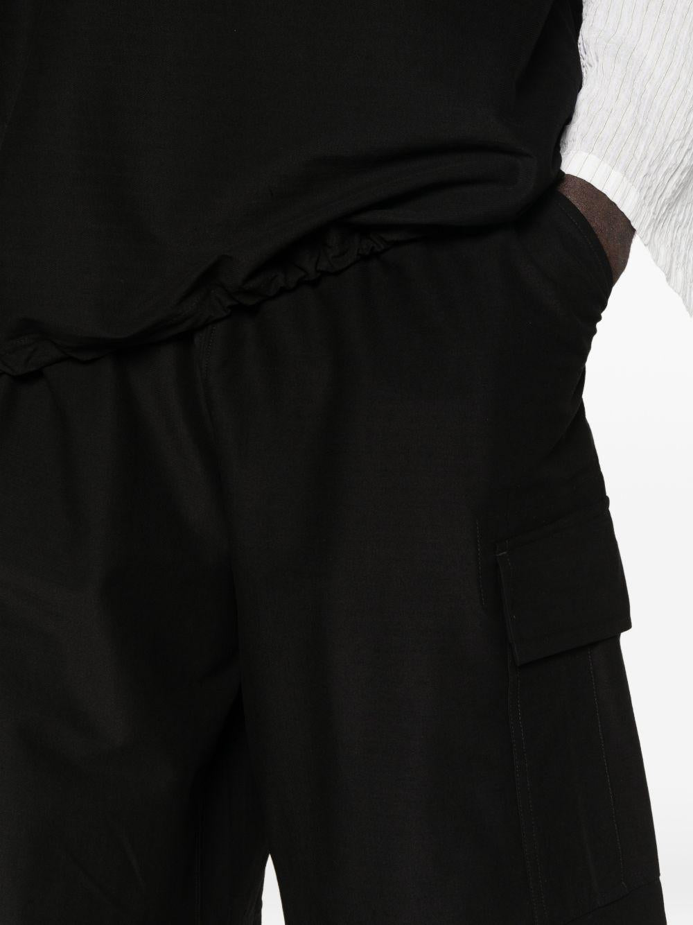 Pantaloncini cargo con coulisse in nero Comme des garcons homme - uomo 