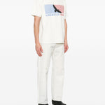 T-shirt con stampa grafica in bianco Rhude  - uomo 