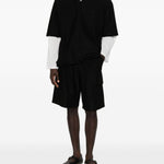 Polo con orlo elasticizzato in nero Comme des garcons homme - uomo 
