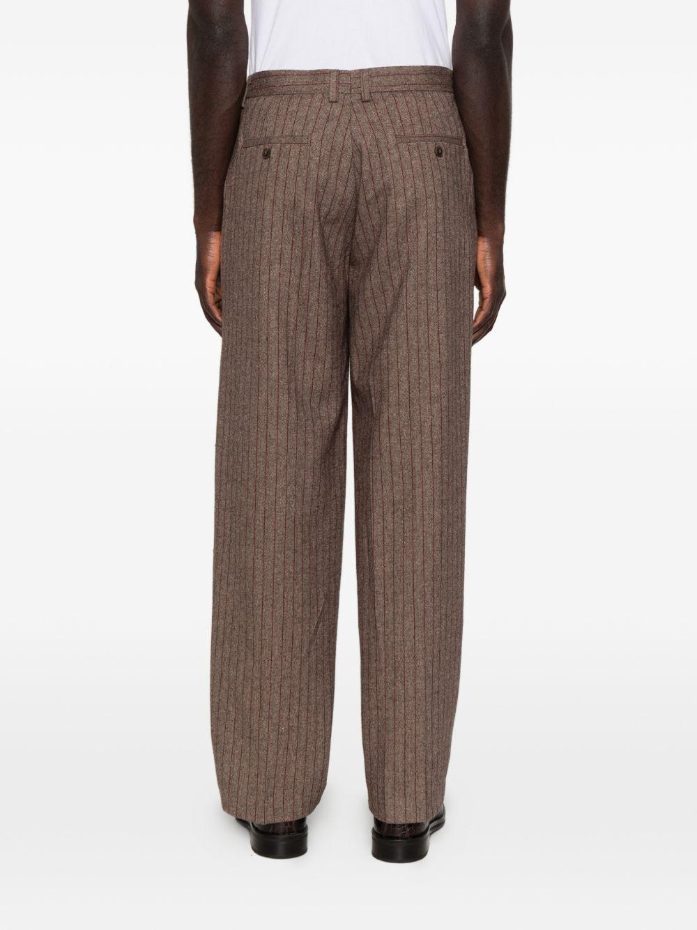 Pantaloni a righe con design patchwork  in marrone Kidsuper - uomo 
