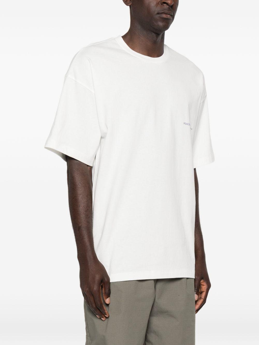T-shirt con stampa del logo in bianco Oamc peacemaker - uomo 