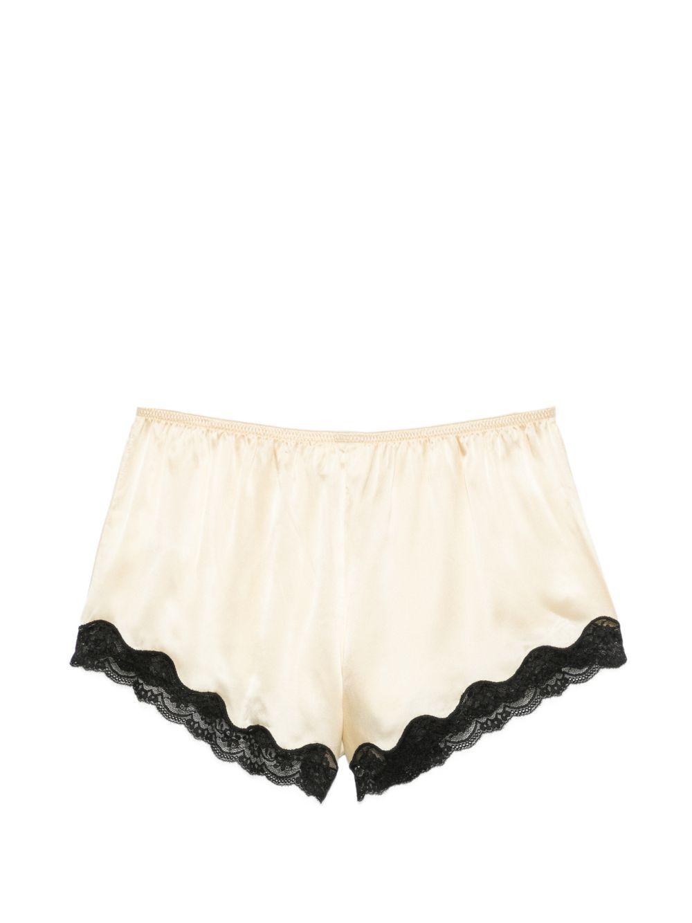 Pantaloncini con bordo in pizzo e fiocco decorativo in beige Rotate x love stories - donna 