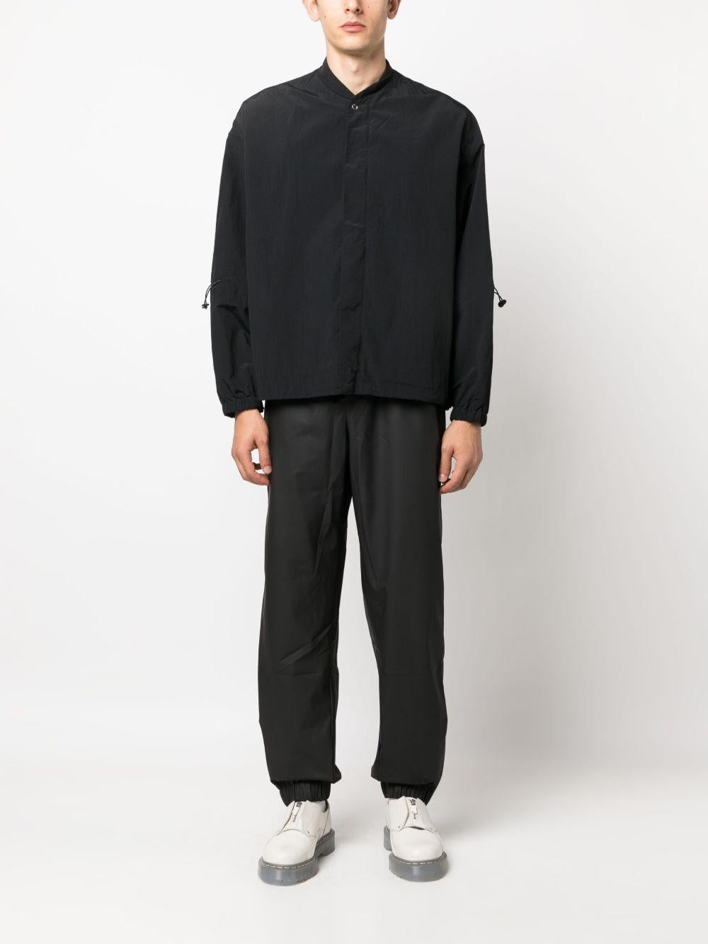 Pantaloni elasticizzati con coulisse in nero Rains - donna 