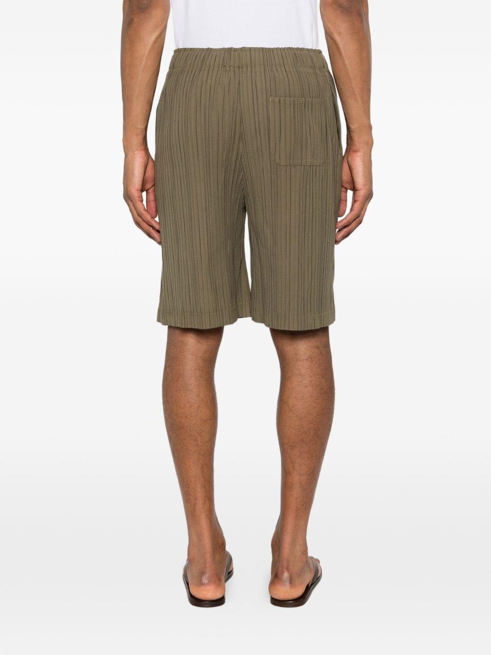 Pantaloncini elasticizzati con pieghe in verde Gongdid design - uomo 