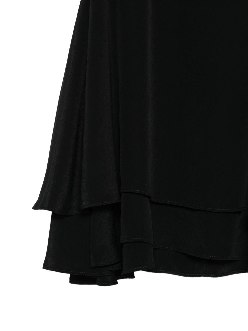 Top con ruchesi in nero 