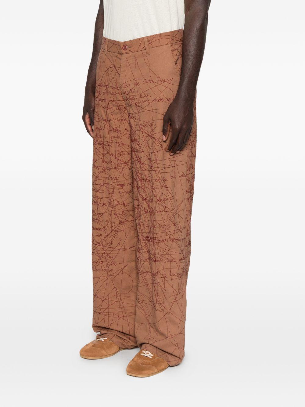 Pantaloni con motivo a scrittura ricamata in marrone Kidsuper - uomo 