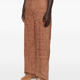 Pantaloni con motivo a scrittura ricamata in marrone Kidsuper - uomo 