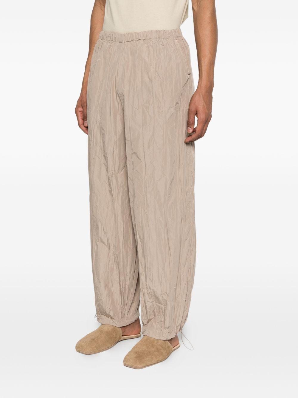 Pantaloni con vita elasticizzata in beige Gongdid design - uomo 