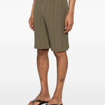Pantaloncini elasticizzati con pieghe in verde Gongdid design - uomo 