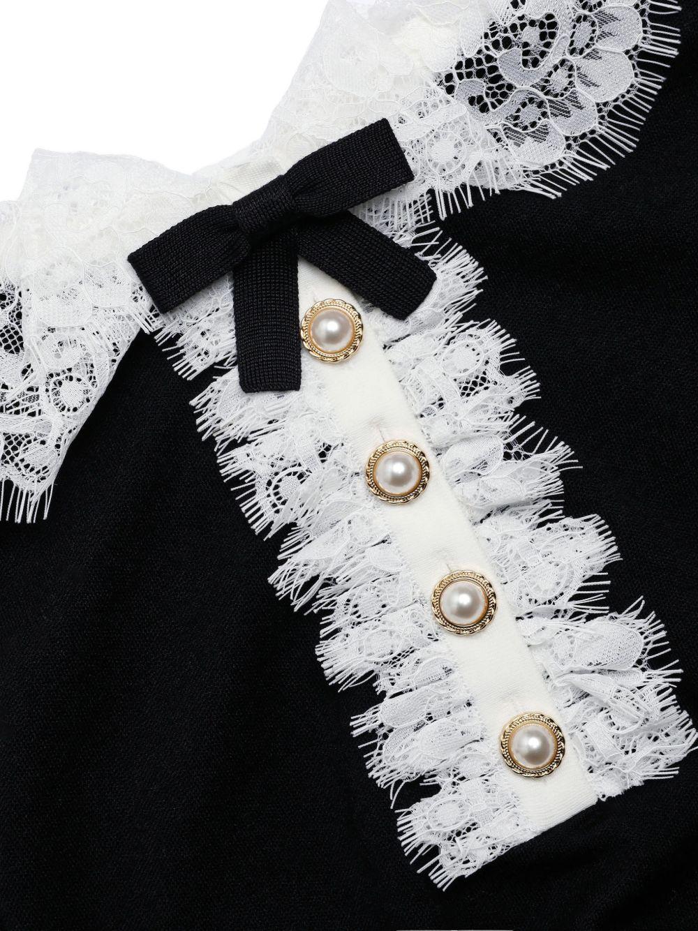 Polo con colletto in pizzo in nero 