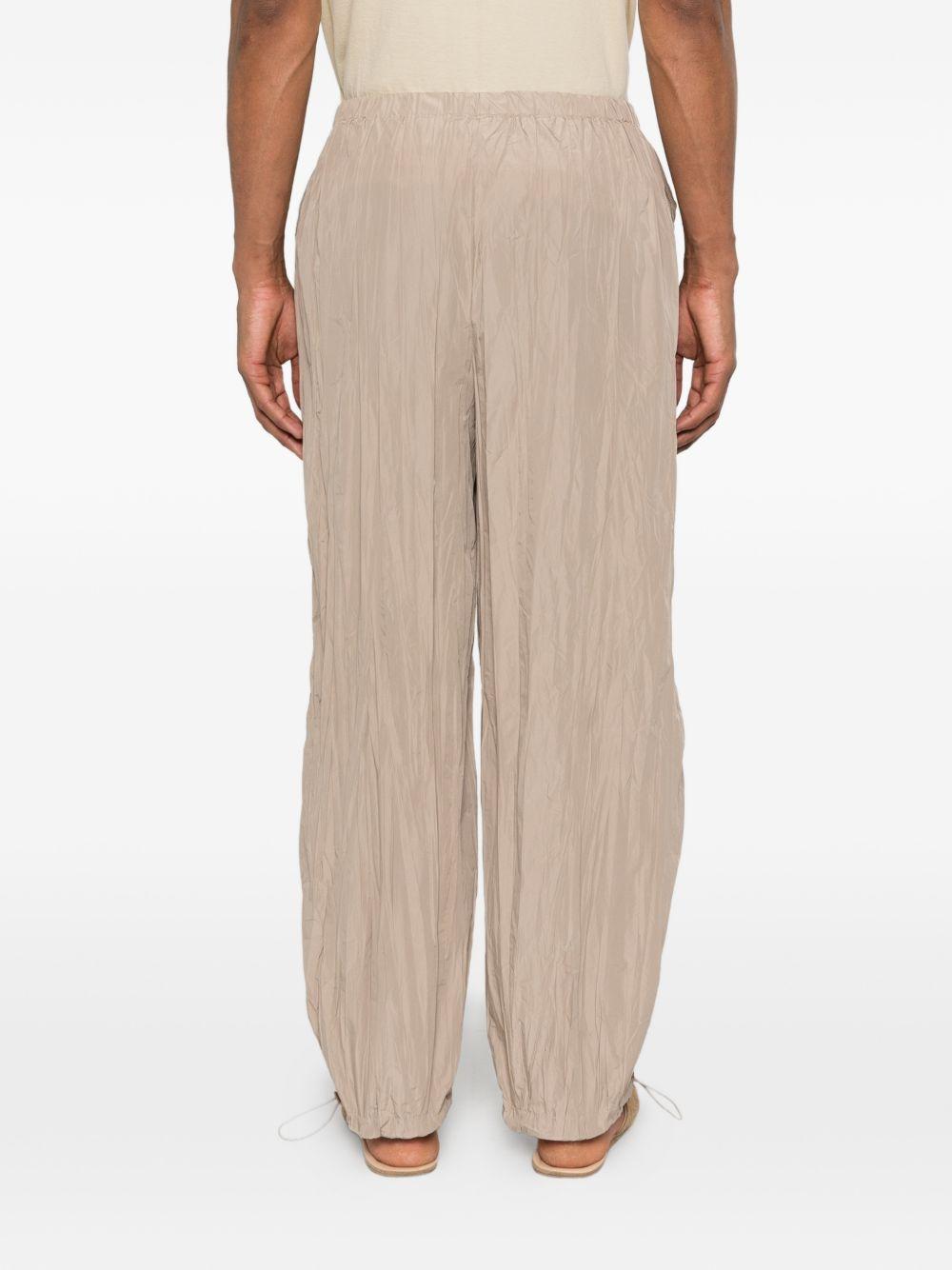 Pantaloni con vita elasticizzata in beige Gongdid design - uomo 