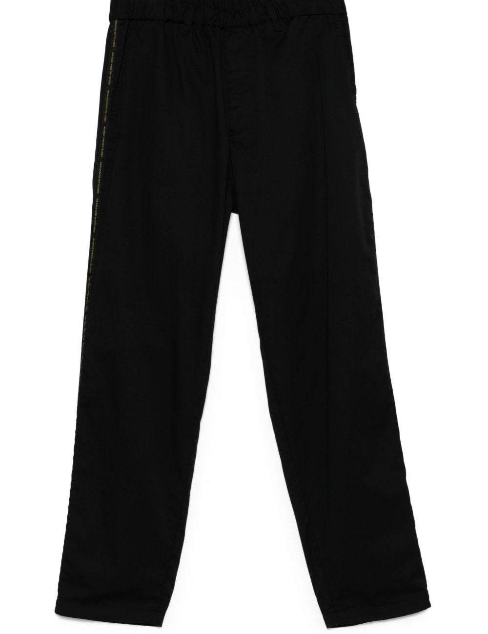 Pantaloni con banda logo in nero Undercover - uomo 