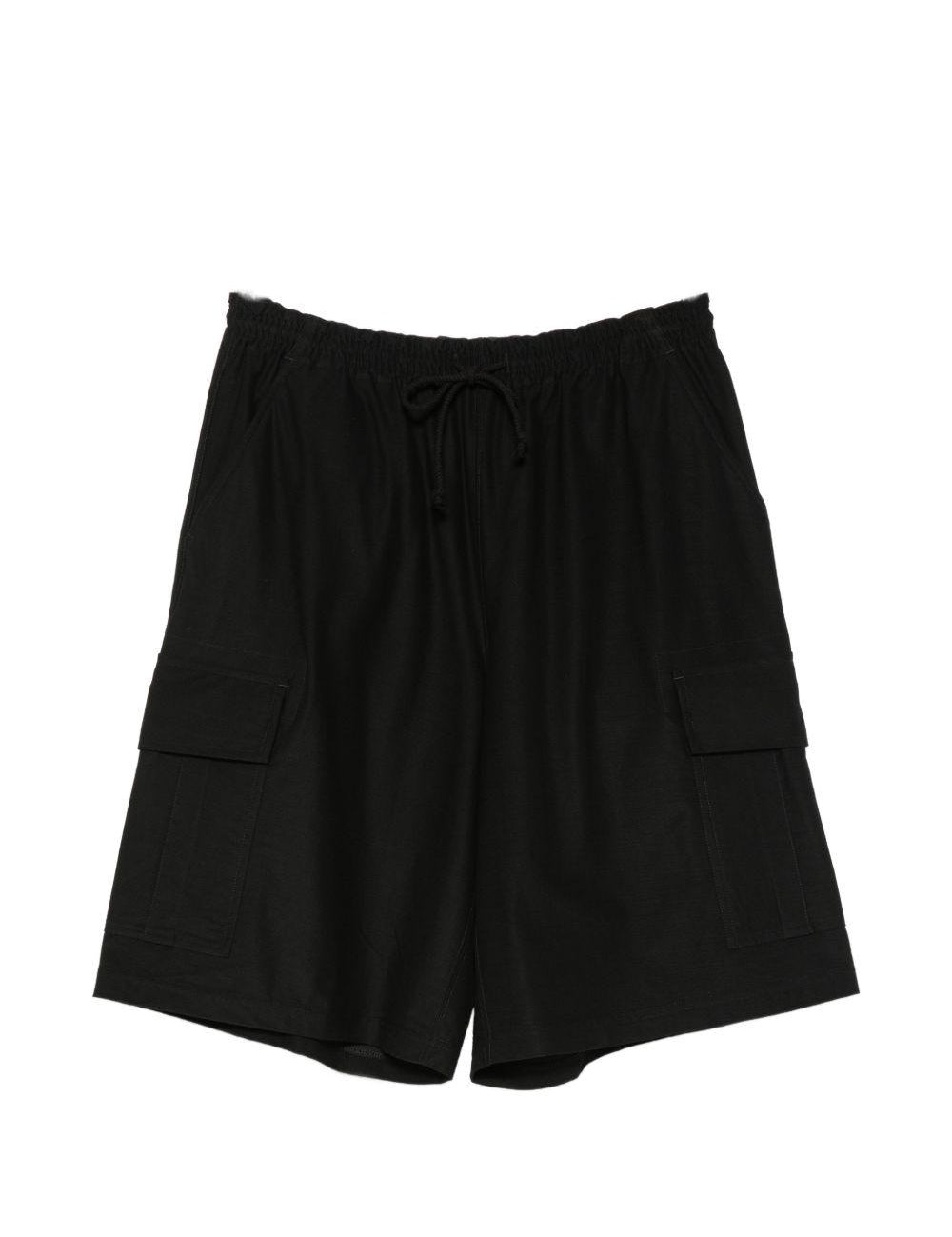 Pantaloncini cargo con coulisse in nero Comme des garcons homme - uomo 